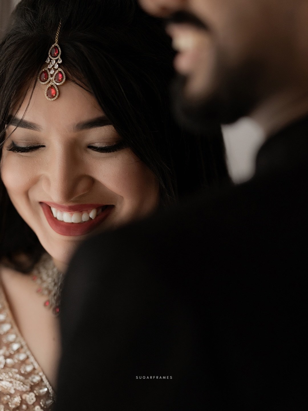 A smiling bride in an intimate close-up portrait with her partner